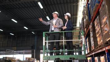 Business woman and warehouse workers are reviewing the list of items based on the documentation,84 photo