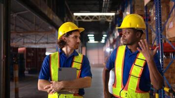 A bunch of warehouse workers are reviewing the list of items based on the documentation,78 photo