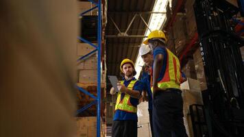 A bunch of warehouse workers are reviewing the list of items based on the documentation,58 photo