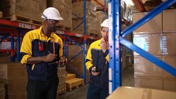 Two warehouse workers are reviewing the list of items based on the documentation,55 photo