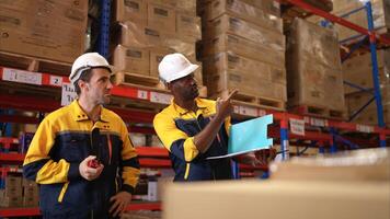 Two warehouse workers are reviewing the list of items based on the documentation,51 photo