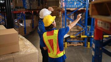 A bunch of warehouse workers are reviewing the list of items based on the documentation,46 photo