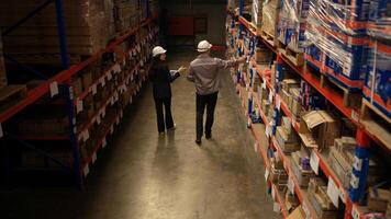 Business woman and warehouse workers are reviewing the list of items based on the documentation,42 photo
