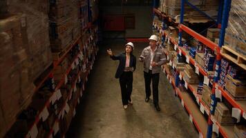Business woman and warehouse workers are reviewing the list of items based on the documentation,40 photo