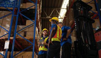 A bunch of warehouse workers are reviewing the list of items based on the documentation,22 photo