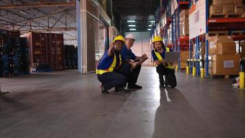 A bunch of warehouse workers are reviewing the list of items based on the documentation,10 photo