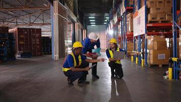 A bunch of warehouse workers are reviewing the list of items based on the documentation,9 photo