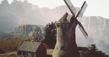 CGI Rustic windmill standing tall in the misty mountains during twilight hours video