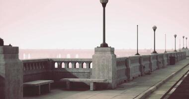 CGI City walkway with benches and streetlights alongside a foggy river video