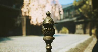 CGI Sculpted ornament stands guard in a tranquil street under blossoming trees video