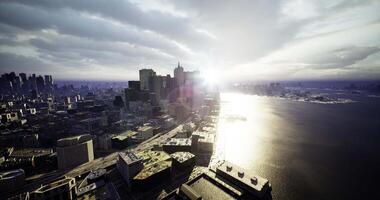 CGI City skyline with sunset reflecting on water and clouds over modern buildings video