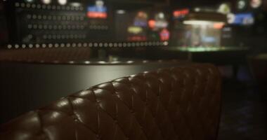 CGI Dimly lit lounge with leather seating and sports screens in the background video
