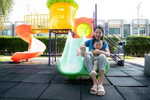 While in vacation at home, a mother engages in activities with little kid in the park,52 photo