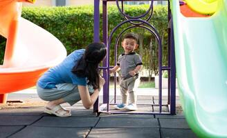 While in vacation at home, a mother engages in activities with little kid in the park,34 photo