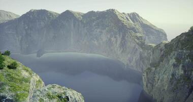 CGI Majestic cliffs embrace a calm lake at dawn in a remote setting video