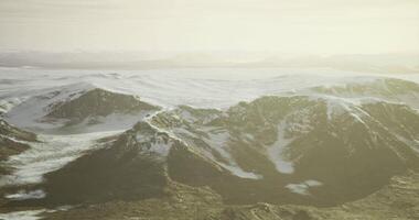 CGI Expansive view of snow covered mountains during golden hour in remote landscape video