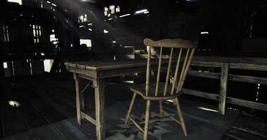 CGI Abandoned wooden chair and table in a dimly lit barn during the day video