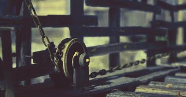 CGI Rusty pulley system in an old wooden framework at an abandoned location video