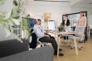 In a contemporary office, a group of senior executives with a mission to approve new projects,152 photo