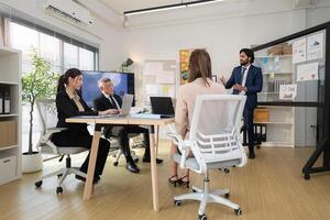 In a contemporary office, a group of senior executives with a mission to approve new projects,129 photo