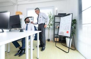 In a contemporary office, two senior executives with a mission to brainstorm and monitor,99 photo