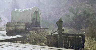 CGI Wagon and water pump in a dusty western landscape during golden hour video