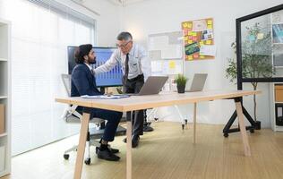 In a contemporary office, two senior executives with a mission to brainstorm and monitor,78 photo