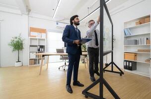 In a contemporary office, two senior executives with a mission to brainstorm and monitor,66 photo