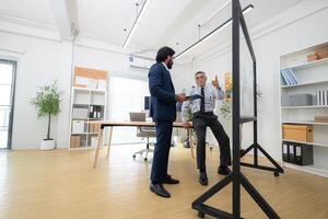 In a contemporary office, two senior executives with a mission to brainstorm and monitor,41 photo