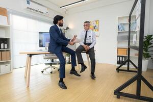 In a contemporary office, two senior executives with a mission to brainstorm and monitor,25 photo