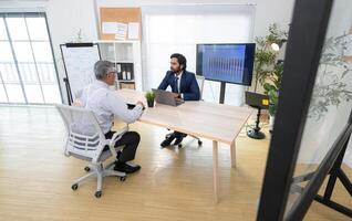 In a contemporary office, two senior executives with a mission to brainstorm and monitor,24 photo