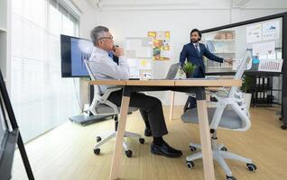 In a contemporary office, two senior executives with a mission to brainstorm and monitor,14 photo