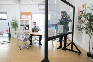 In a contemporary office, two senior executives with a mission to brainstorm and monitor,11 photo