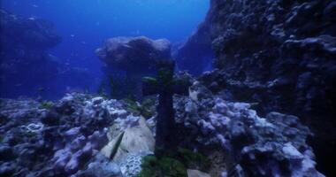 CGI Underwater exploration of an ancient stone cross in a vibrant reef video