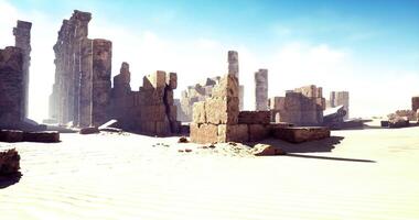 CGI Ruins of ancient structures surrounded by golden sand under clear sky video