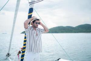 A young man is enjoying his seaside adventure aboard a yacht,119 photo