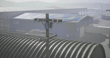 CGI Detailed view of utility pole with solar panels and warehouses in foggy weather video