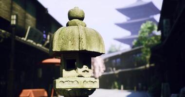CGI Ancient lantern stands in quiet street with pagoda in background during daytime video