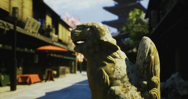CGI Ancient stone lion guardian in a traditional street setting at noon video