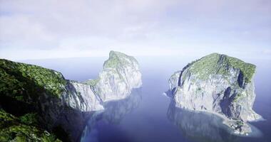 CGI Majestic coastal cliffs rise above tranquil waters in a serene landscape video