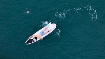A young man is enjoying his ocean adventure aboard a yacht and surfboard,14 photo