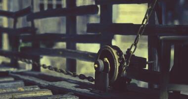 CGI Detailed view of an old pulley system with a chain on a wooden structure video