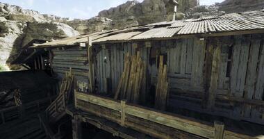 CGI Rustic wooden structure nestled among rocky terrain under clear skies video