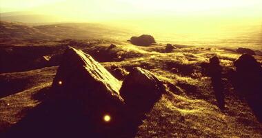 CGI Scenic view of sunlit hills and distant landscape during golden hour video