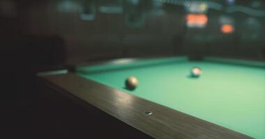 CGI Pool table with three balls in a dimly lit game room setting video
