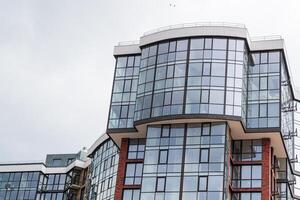Modern apartment building. Multi Storey modern, new and stylish living block of flats. Fragment of a new elite residential building or commercial complex photo
