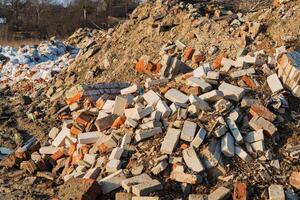 A pile of building bricks. Unused bricks after construction. Garbage remained after construction. Pile of concrete debris photo