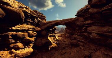 CGI Natural rock formation with arch in a desert landscape under blue sky video