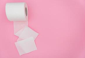 White roll of toilet paper on color background. Hygiene concept. Empty place for text or logo photo