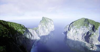 CGI Majestic coastal cliffs surrounded by tranquil waters under soft daylight video